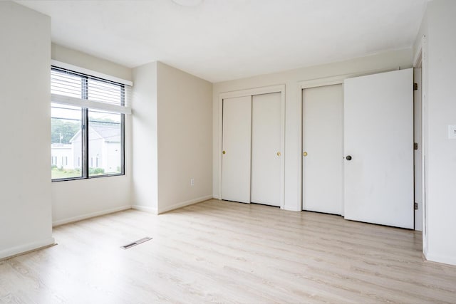 329 W Main St Unit 30, Hyannis, MA 02601 - unfurnished bedroom featuring two closets and light wood finished floors