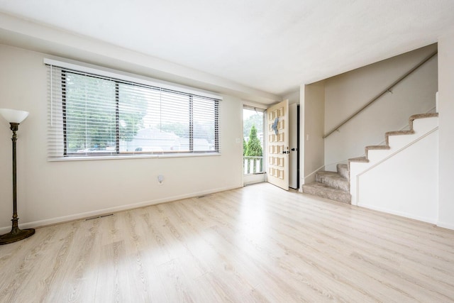 329 W Main St Unit 30, Hyannis, MA 02601 - unfurnished living room with wood finished floors, plenty of natural light, and stairway