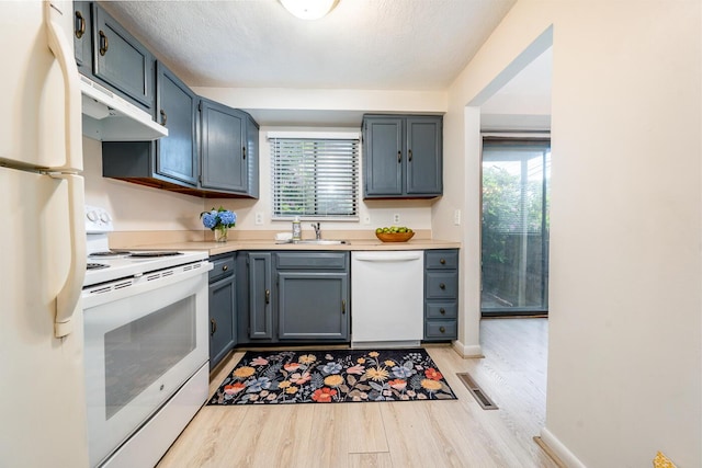 329 W Main St Unit 30, Hyannis, MA 02601 - kitchen with white appliances, under cabinet range hood, light wood-type flooring, and healthy amount of natural light
