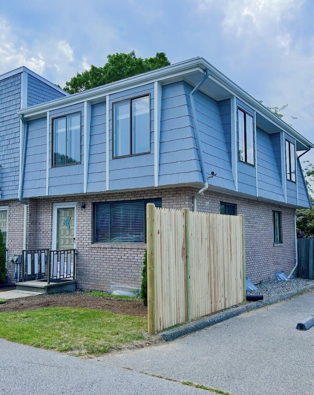 329 W Main St Unit 30, Hyannis, MA 02601 - view of property exterior with brick siding and mansard roof
