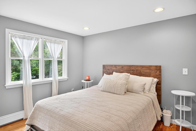 908 W Falmouth Hwy, Falmouth, MA 02540 - bedroom with a baseboard heating unit, wood finished floors, and recessed lighting