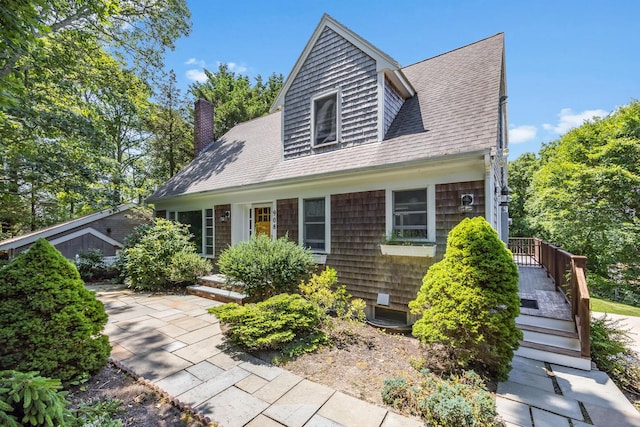 908 W Falmouth Hwy, Falmouth, MA 02540 - view of front of property with roof with shingles and a chimney