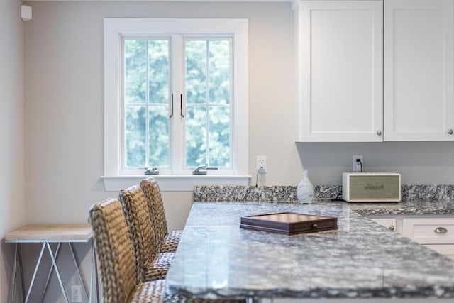 908 W Falmouth Hwy, Falmouth, MA 02540 - kitchen with light stone countertops and white cabinets