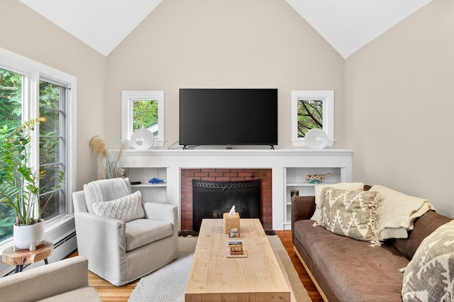 908 W Falmouth Hwy, Falmouth, MA 02540 - living room featuring wood finished floors, a brick fireplace, and high vaulted ceiling