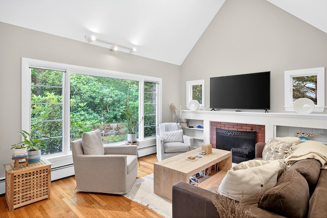 908 W Falmouth Hwy, Falmouth, MA 02540 - living room featuring high vaulted ceiling, baseboard heating, wood finished floors, and a fireplace