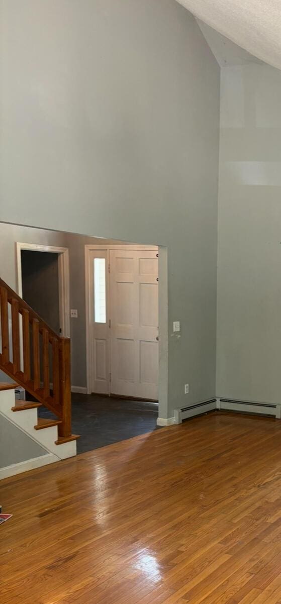 62 Musket Ln, Mashpee, MA 02649 - foyer entrance featuring high vaulted ceiling, stairs, and wood finished floors