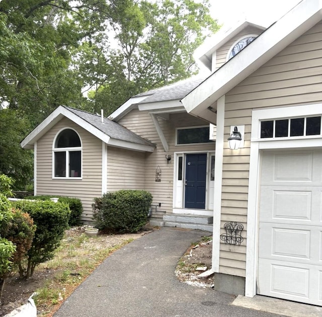 62 Musket Ln, Mashpee, MA 02649 - property entrance with an attached garage and a shingled roof