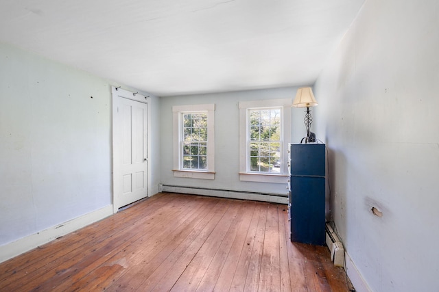 1424 Main St, Brewster, MA 02631 - unfurnished bedroom with a baseboard heating unit, hardwood / wood-style flooring, and baseboards