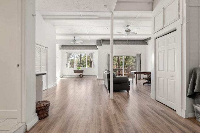 sitting room with a ceiling fan and light wood-style floors