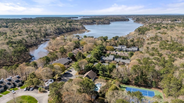 aerial overview of property's location featuring a large body of water and a heavily wooded area