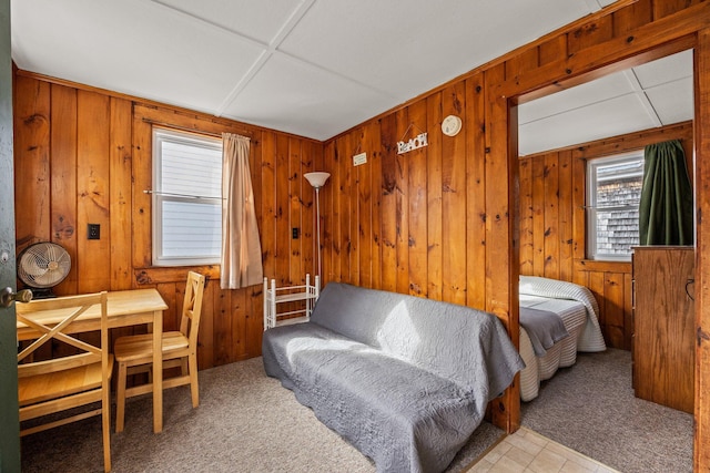 carpeted bedroom with wooden walls