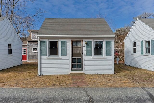 view of front of property with roof with shingles and an outdoor structure