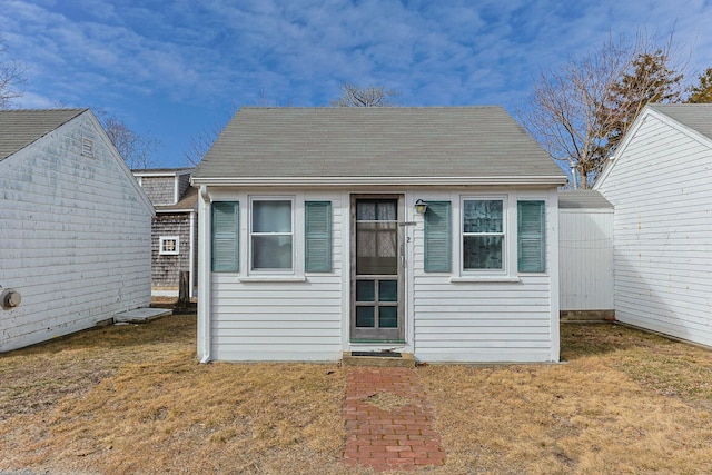 view of front of house with an outbuilding and a front yard