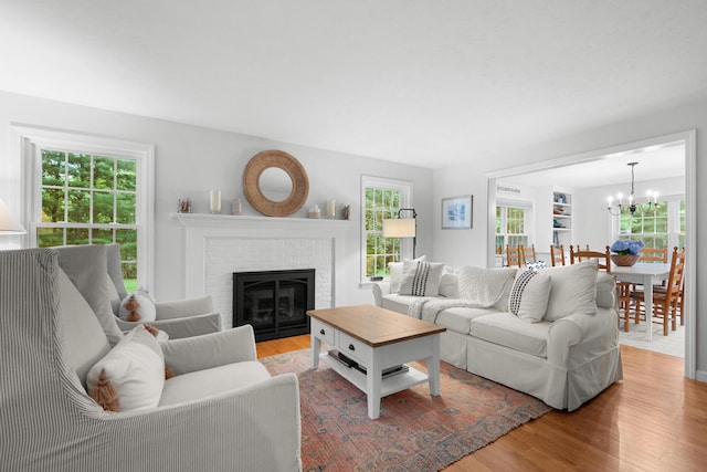 95 Red Brook Rd, Waquoit, MA 02536 - living area with wood finished floors, a chandelier, and healthy amount of natural light