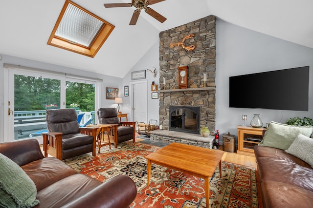 95 Red Brook Rd, Waquoit, MA 02536 - living area featuring a ceiling fan, wood finished floors, a skylight, a stone fireplace, and high vaulted ceiling
