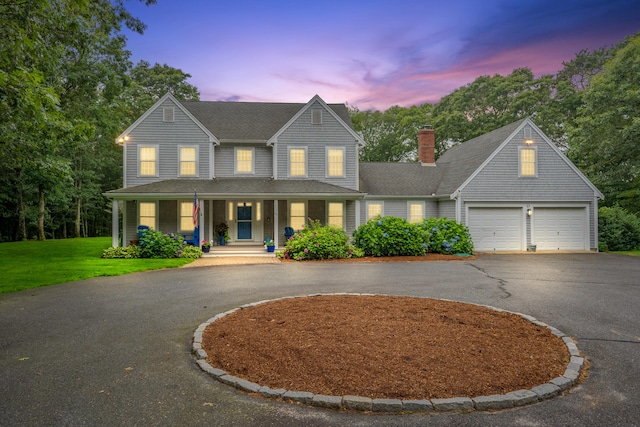 95 Red Brook Rd, Waquoit, MA 02536 - view of front of property featuring curved driveway, a porch, a chimney, a front lawn, and a garage