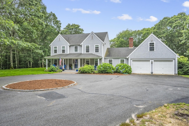 95 Red Brook Rd, Waquoit, MA 02536 - farmhouse inspired home with asphalt driveway, a porch, a garage, and a chimney