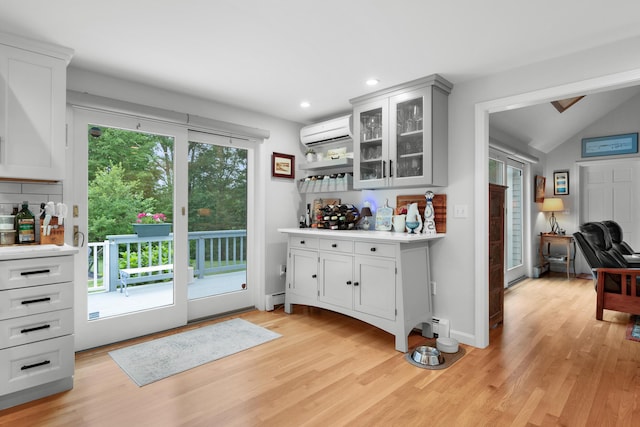 95 Red Brook Rd, Waquoit, MA 02536 - indoor dry bar featuring a wall unit AC, light wood-style flooring, recessed lighting, lofted ceiling, and baseboard heating