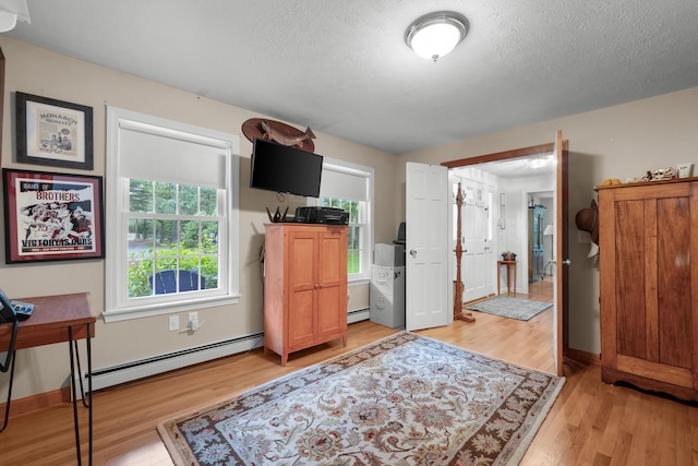 95 Red Brook Rd, Waquoit, MA 02536 - bedroom with a baseboard radiator, light wood finished floors, and a textured ceiling