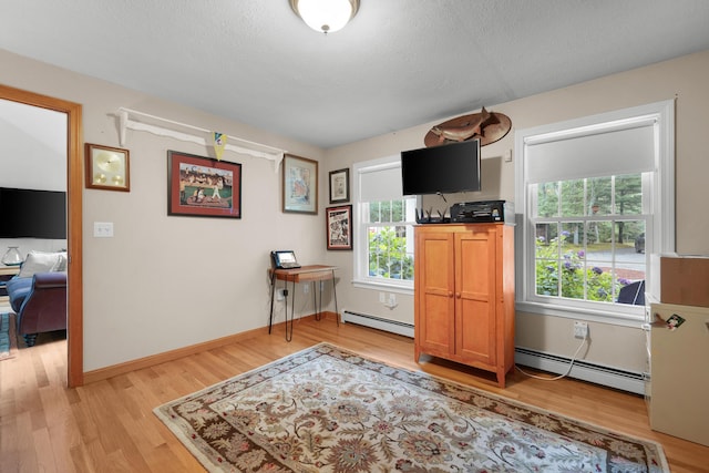 95 Red Brook Rd, Waquoit, MA 02536 - sitting room with a baseboard heating unit, light wood finished floors, and a textured ceiling