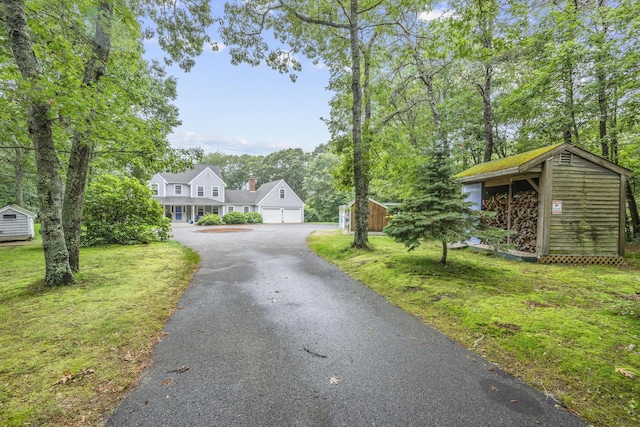 95 Red Brook Rd, Waquoit, MA 02536 - view of front of property featuring a storage unit, a front yard, and a garage