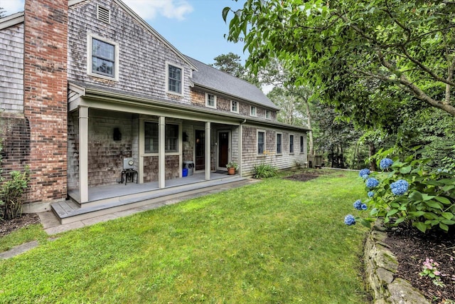 37 Tobisset St, Mashpee, MA 02649 - back of property featuring covered porch and a yard