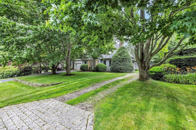 37 Tobisset St, Mashpee, MA 02649 - view of front facade with a front lawn and a garage