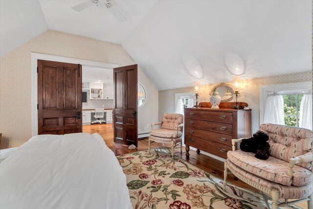 37 Tobisset St, Mashpee, MA 02649 - bedroom with wallpapered walls, lofted ceiling, wood finished floors, multiple windows, and a baseboard heating unit