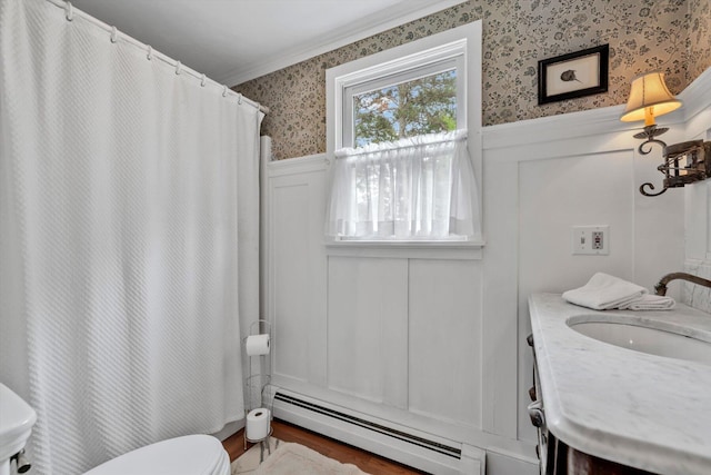 37 Tobisset St, Mashpee, MA 02649 - bathroom with baseboard heating, ornamental molding, wainscoting, wallpapered walls, and a decorative wall