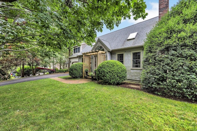 37 Tobisset St, Mashpee, MA 02649 - view of front of home with a front lawn and a chimney