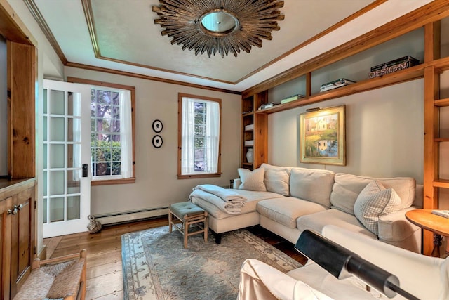 37 Tobisset St, Mashpee, MA 02649 - living room with baseboard heating, hardwood / wood-style floors, ornamental molding, and a raised ceiling
