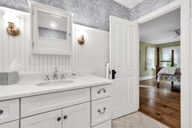 37 Tobisset St, Mashpee, MA 02649 - bathroom featuring wallpapered walls, vanity, a ceiling fan, and marble look tiles