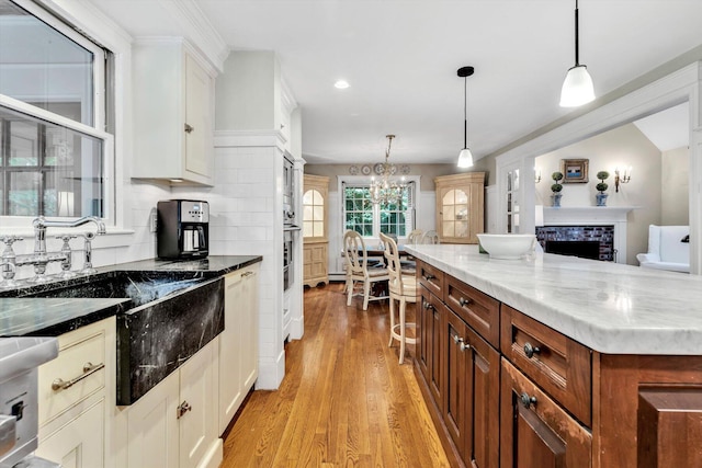 37 Tobisset St, Mashpee, MA 02649 - kitchen with light wood finished floors, tasteful backsplash, white cabinetry, hanging light fixtures, and recessed lighting