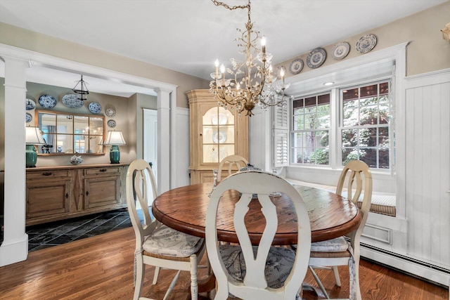 37 Tobisset St, Mashpee, MA 02649 - dining area featuring baseboard heating, ornate columns, a chandelier, and dark wood finished floors
