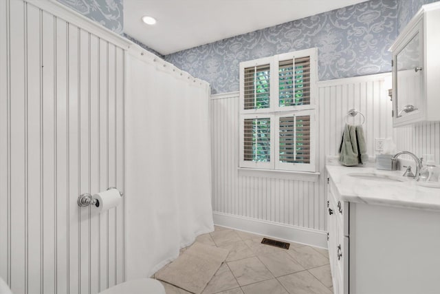 37 Tobisset St, Mashpee, MA 02649 - bathroom with wallpapered walls, vanity, a wainscoted wall, marble finish floors, and a shower with shower curtain