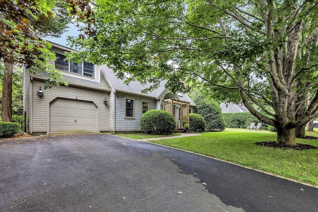 37 Tobisset St, Mashpee, MA 02649 - view of front facade with a garage, a front lawn, a shingled roof, and driveway