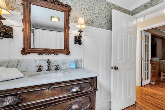 37 Tobisset St, Mashpee, MA 02649 - full bath featuring vanity, wainscoting, wood finished floors, wallpapered walls, and ornamental molding
