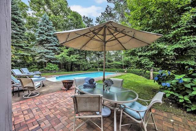 37 Tobisset St, Mashpee, MA 02649 - view of patio / terrace with outdoor dining area, an outdoor pool, and view of wooded area