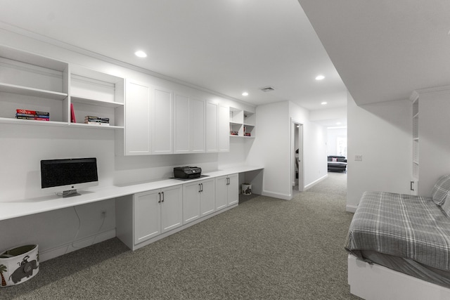 carpeted office featuring recessed lighting, visible vents, baseboards, and built in study area