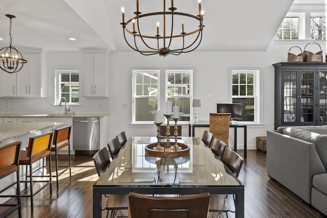 dining space with dark wood-style floors, recessed lighting, a healthy amount of sunlight, and an inviting chandelier