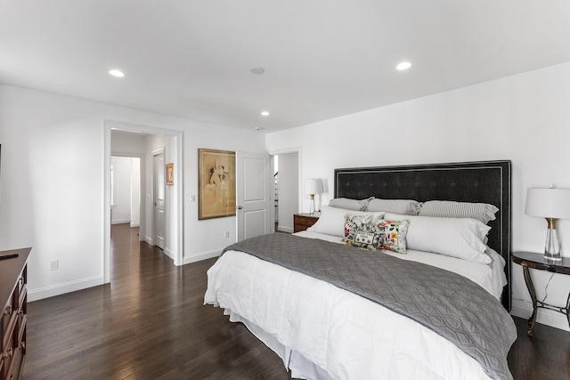 bedroom with recessed lighting, dark wood finished floors, and baseboards