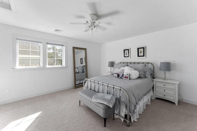 bedroom featuring light carpet, ceiling fan, visible vents, and baseboards