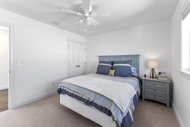 bedroom with carpet floors, a ceiling fan, visible vents, and baseboards