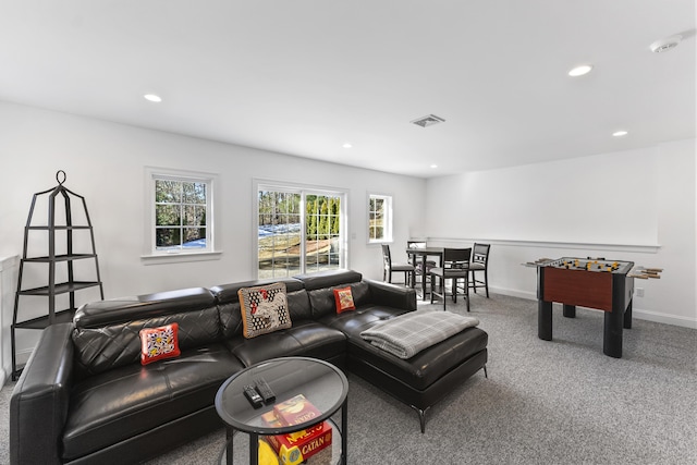 carpeted living room featuring baseboards, visible vents, and recessed lighting