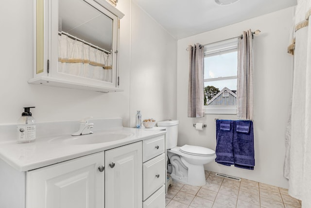 bathroom featuring toilet, tile patterned floors, visible vents, and vanity