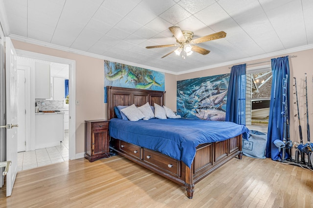 bedroom featuring crown molding and light wood-style flooring