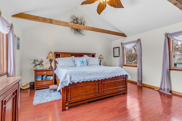 bedroom featuring baseboards, a ceiling fan, wood finished floors, and vaulted ceiling