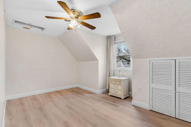 bonus room with baseboards, a ceiling fan, light wood-style flooring, and vaulted ceiling