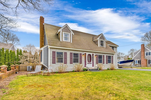 cape cod-style house featuring driveway, a chimney, a front yard, central AC unit, and fence
