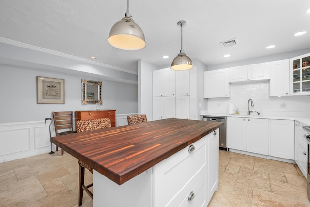 925 Main St Unit 3, Cotuit, MA 02635 - kitchen featuring wooden counters, dishwasher, stone tile floors, a sink, and crown molding